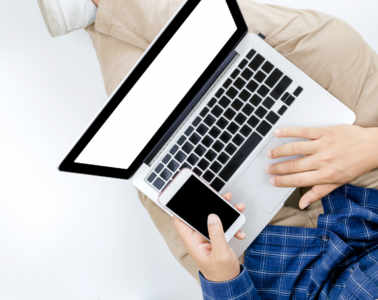 Young Businessman Working At Laptop Computer With Smartphone