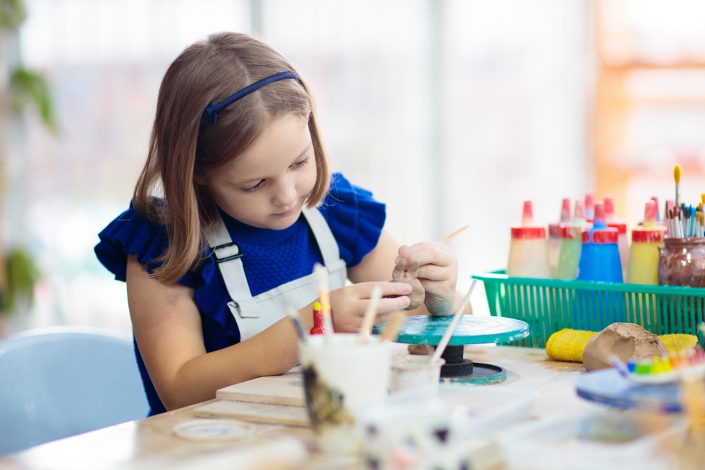 Child,working,on,pottery,wheel.,kids,arts,and,crafts,class
