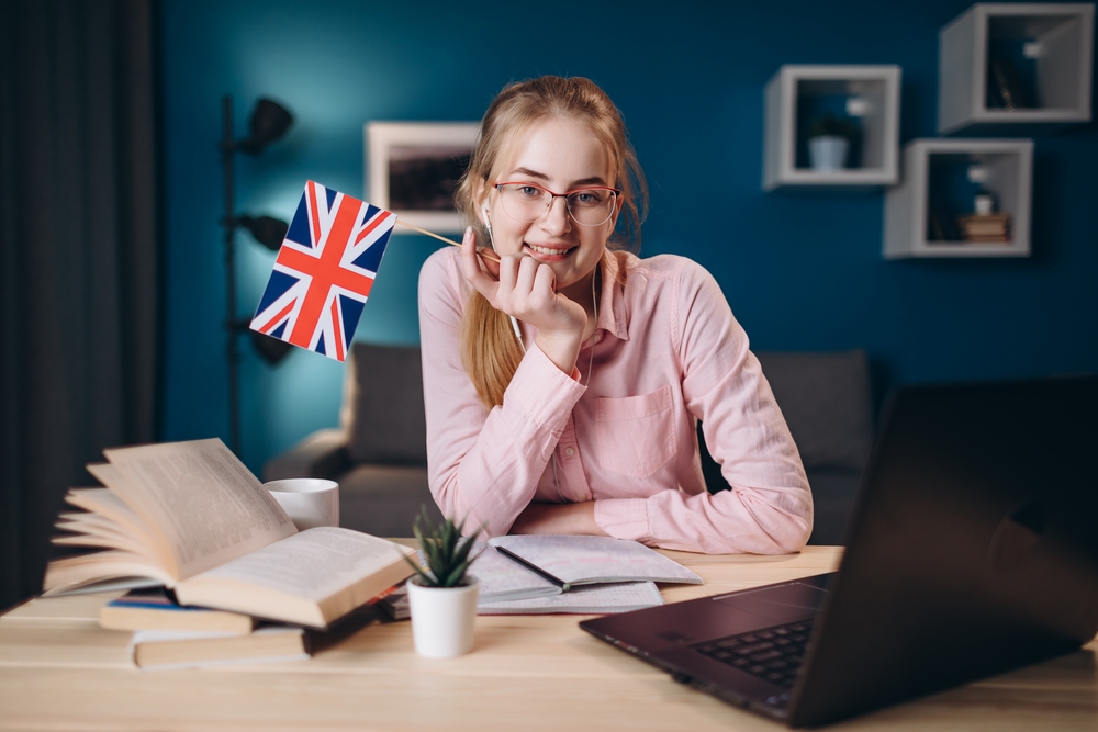 Cute Ginger Girl In Glasses Holding A British Flag